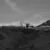 a black and white photo of a bulldozer on a hill